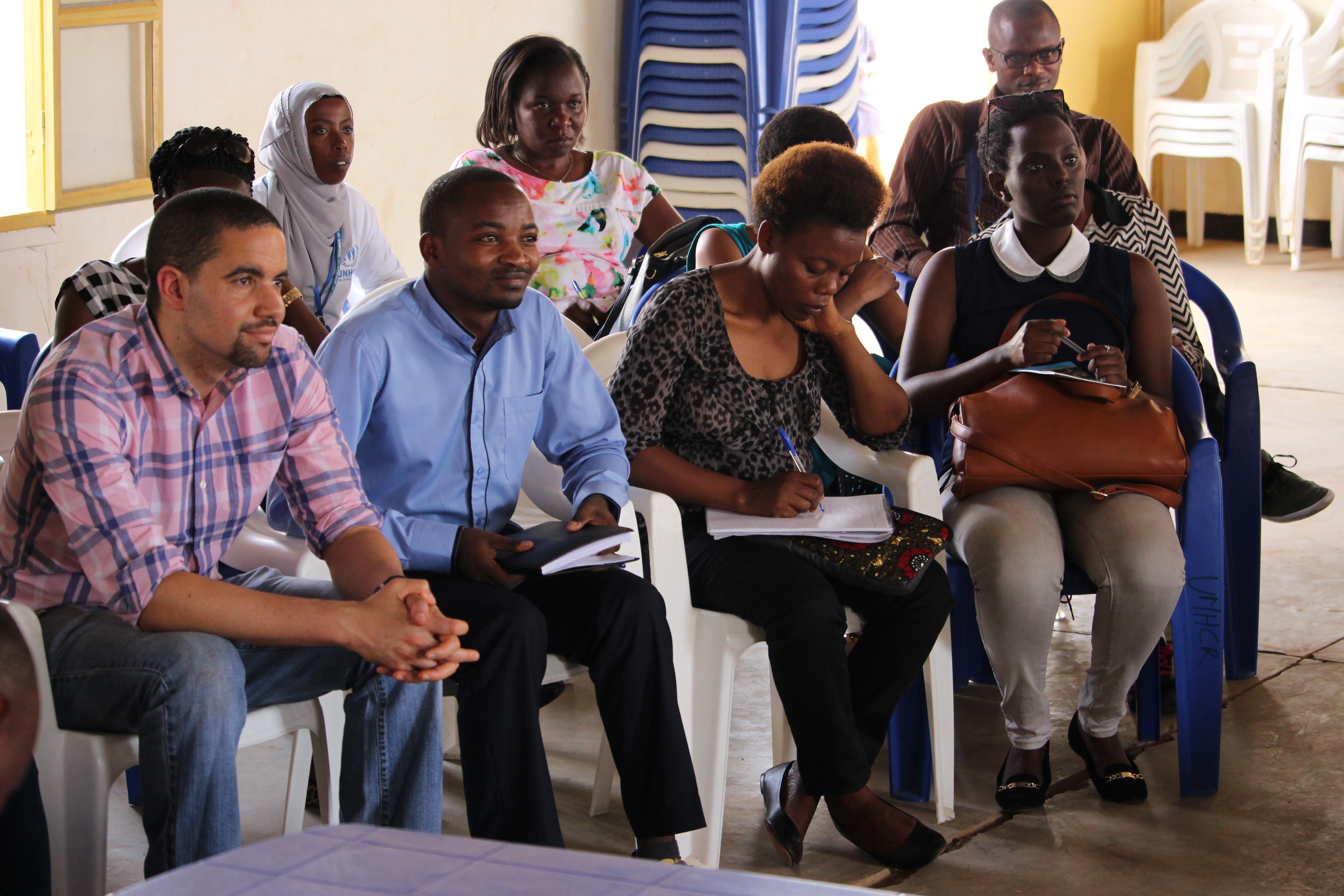 Students and staff of UGHE listen as camp personnel give an overview of Mahama Refugee Camp.